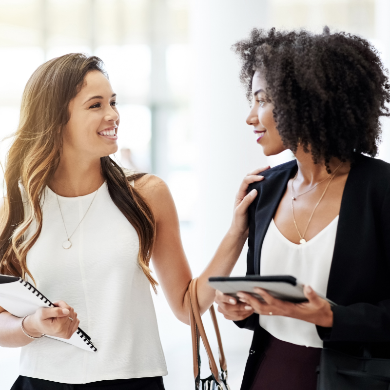 stock image of 2 woman talking, used to build relevance towards intra company myths vs facts page.