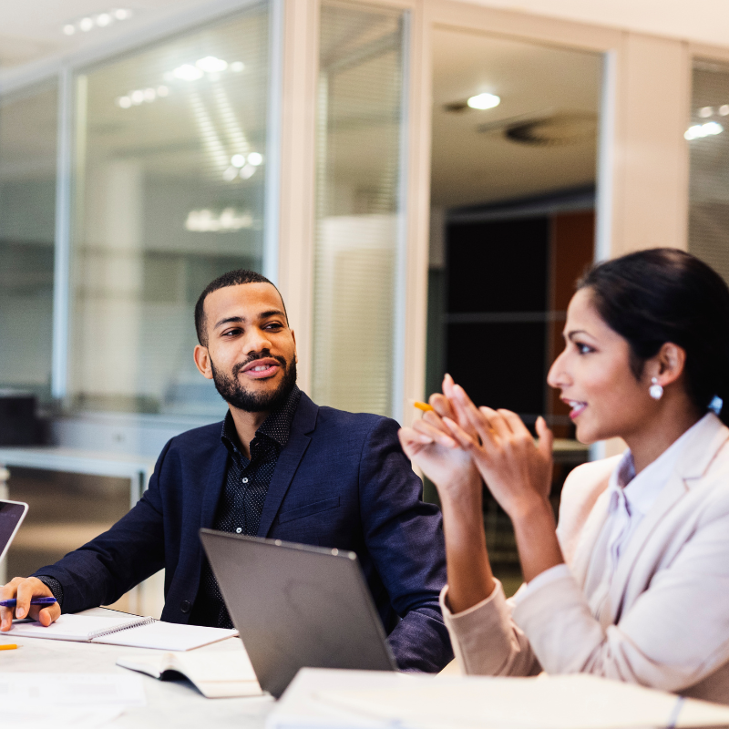Stock image of 2 people having a meeting, a man and a woman, visually building relevance towards intra-company transfer business expansion plan.