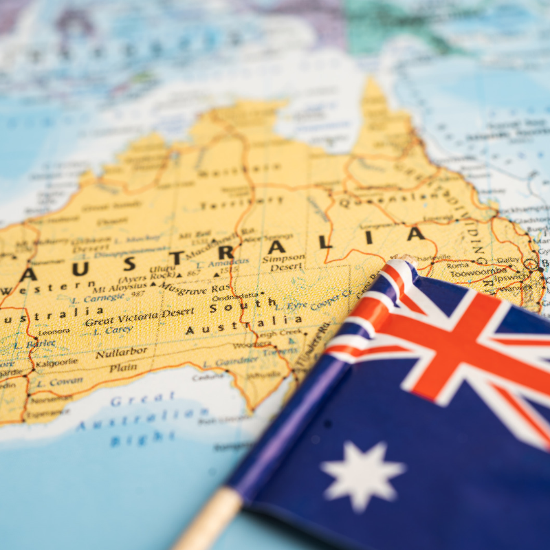 Stock image of Australian flag on a map zoomed in to Australia, used to build relevance to the page content on CPTPP Work Permit.